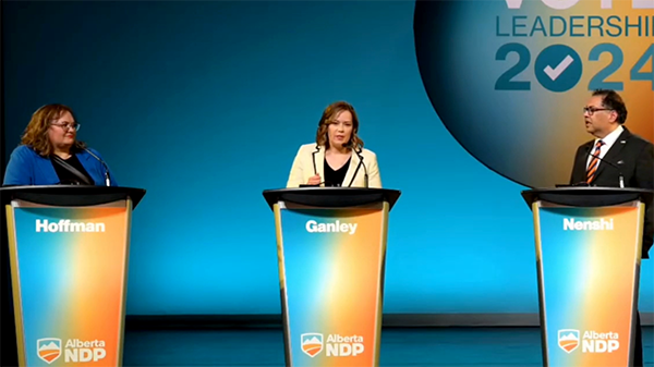 Kathleen Ganley pictured on the debate stage with fellow debaters Sarah Hoffman and Naheed Nenshi